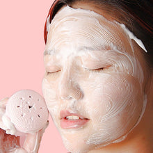 Silicone face scrubber in cute octopus shape, ideal for facial cleansing.